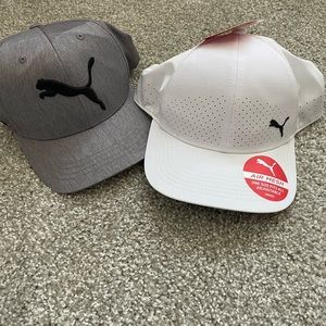 Two men’s puma hats